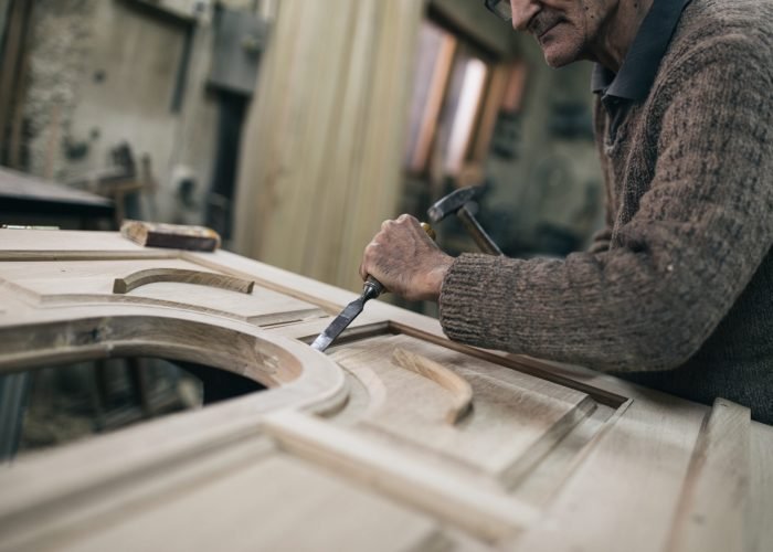 Close up shot of old master carpenter working in his woodwork or workshop