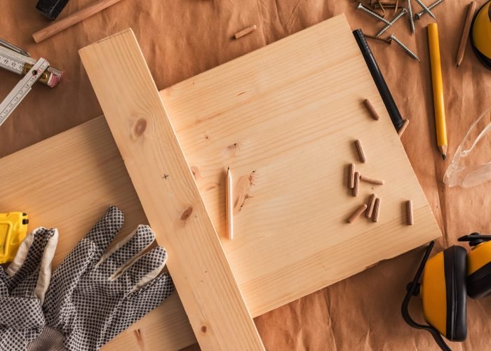 Carpentry woodwork workbench top view with planks and dowels